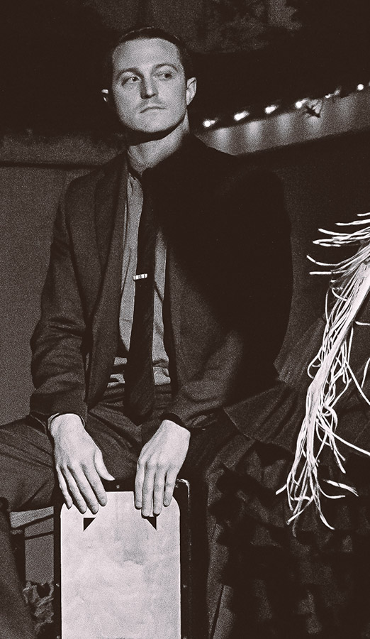 A photo of Dylan Allen playing the cajón