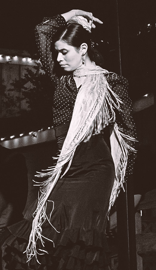 A photo of Lexi Allen dancing flamenco on stage